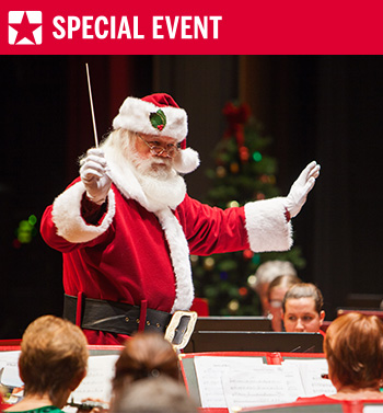 Santa Claus conducts musicians during a holiday pops concert with a Special Event banner.